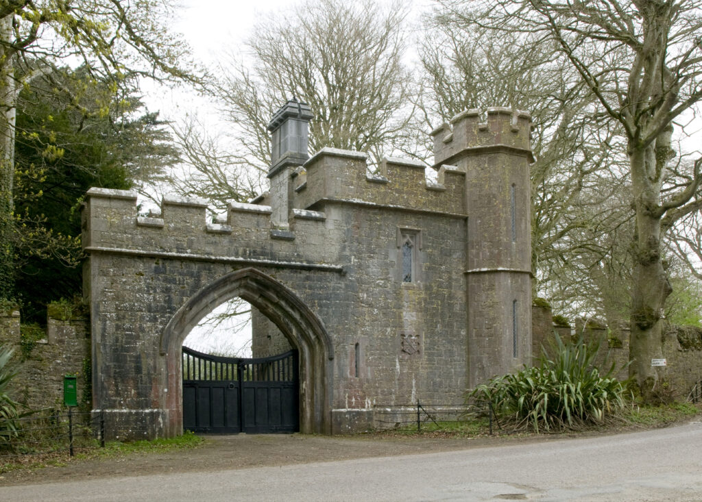 The turreted Gothic gateway of Annes Grove Miniature Castle among beech trees