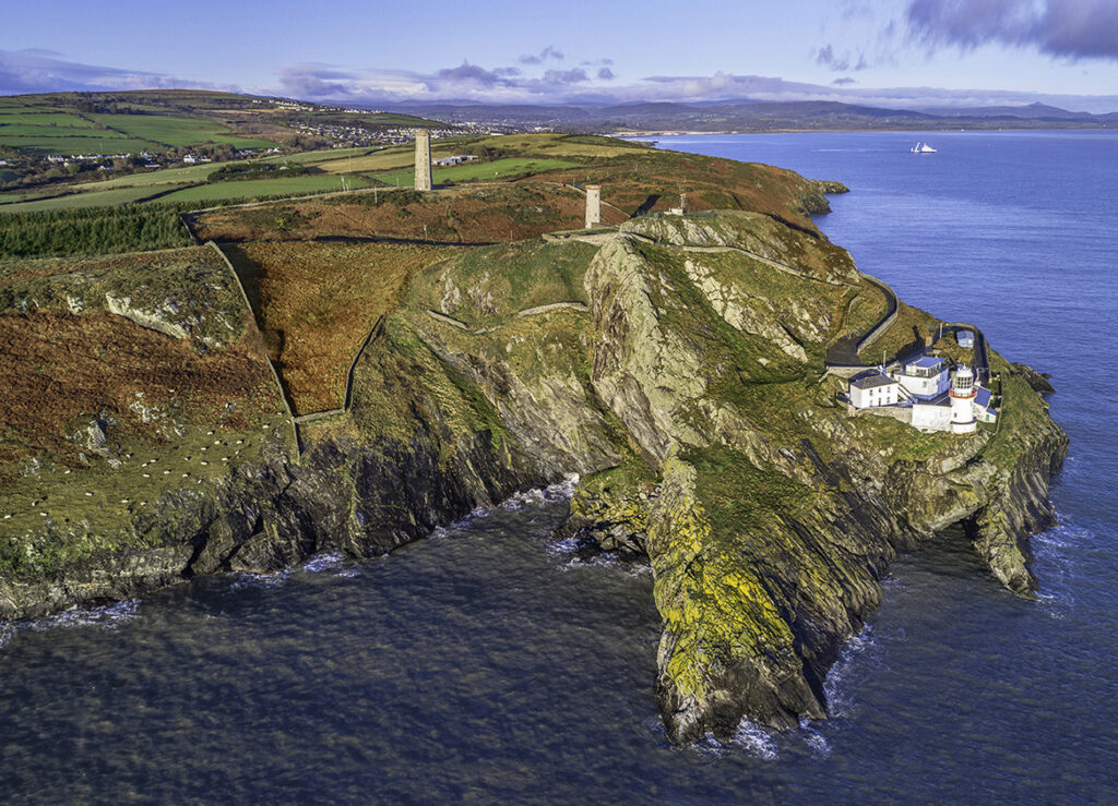 Aerial view of Wicklow Head featuring the current lighthouse nearest the coastline, the "front lighthouse" further up and the old Wicklow Head Lighthouse behind. 