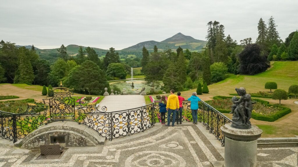 Children looking across Powerscourt gardens with the Sugarloaf in the distance