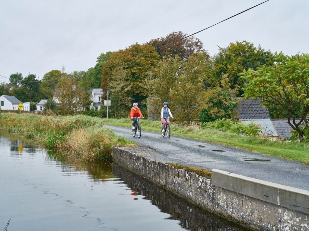 People cycling along a bike path of the Royal Canal Greenway