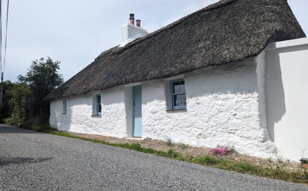 The whitewashed thatched Goggin Cottage in Co. Limerick