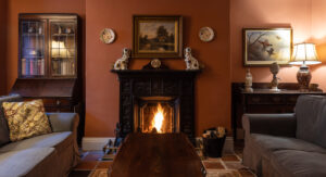 a fire burns in the fireplace of a landmark trust property